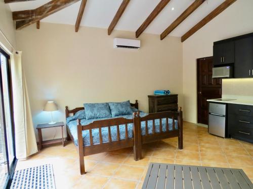a bedroom with a bed in a room with a kitchen at Beachy Studio Hideaway Steps to Sand & Sunset in Playa Flamingo