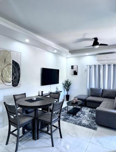 a living room with a table and a couch at Luxury 2Bdrm APT in Montego Bay in Montego Bay