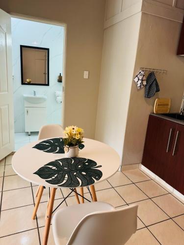 a kitchen with a table and chairs and a sink at Nampaton Farm in Drummond