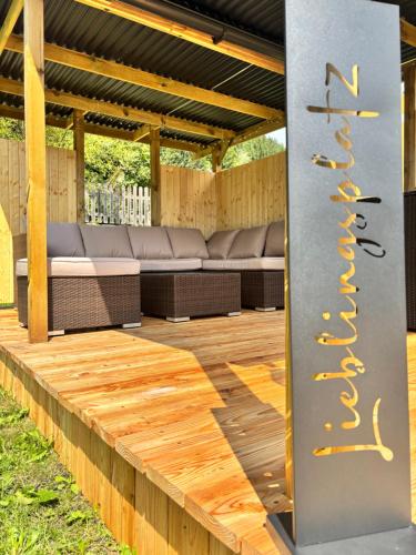 a wooden deck with benches in a pavilion at Ferienwohnung in Mixnitz-Bärenschützklamm 2 in Mixnitz