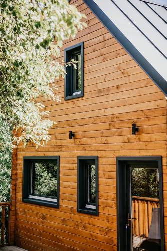 a house with four windows on the side of it at Woodland Noszvaj in Noszvaj