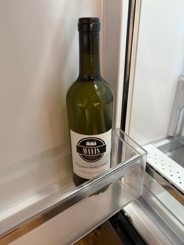 a bottle of wine is sitting in the refrigerator at Apartmán Mavis in Kašperské Hory