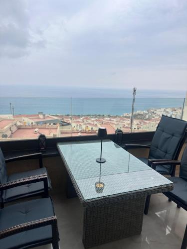 a table and chairs with a view of the ocean at Welcome to THE VIEW! in Al Hoceïma