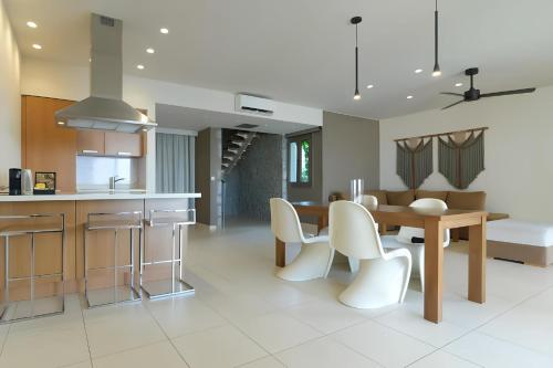 a kitchen and dining room with a table and chairs at The Noverian Scenic Crete 5 Star Hilltop Villa Resort & Spa in Malia