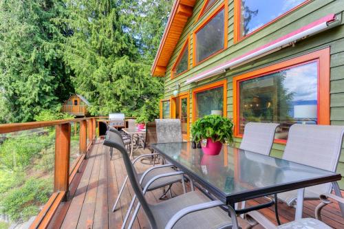 a table and chairs on the deck of a house at Custom Built Home on the Beach in Nelson