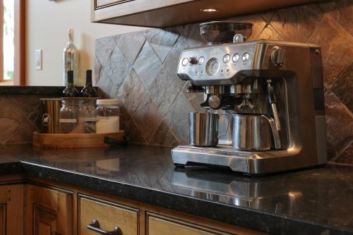 a coffee maker sitting on top of a kitchen counter at Custom Built Home on the Beach in Nelson