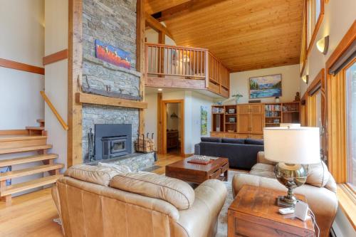 a living room with a couch and a fireplace at Custom Built Home on the Beach in Nelson