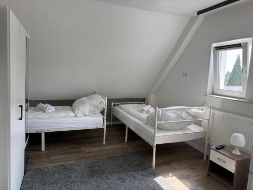 a room with two bunk beds and a window at Hotel Dernbach in Dernbach