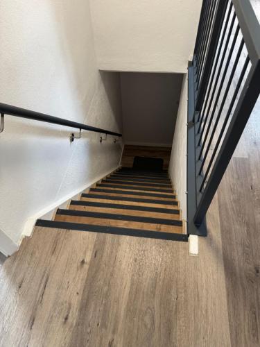 a stairwell with a stair railing and wooden floors at Hotel Dernbach in Dernbach