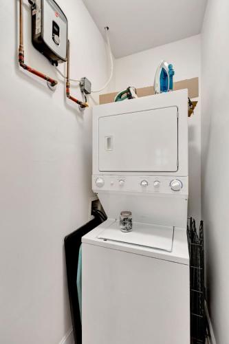 a washer and dryer in a laundry room with a refrigerator at Retreat on Spring, Unit B in Charleston