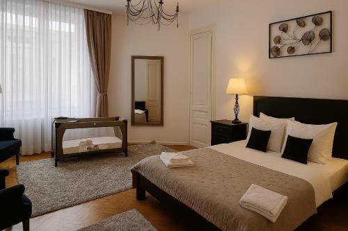 a bedroom with a large bed and a mirror at Mid Ultra Central Apartments, Self Check In in Oradea