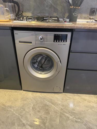 a washing machine in a kitchen with a counter at Melhem Twin Homes in Şamaxı