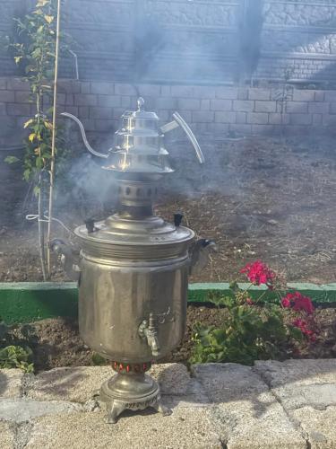 a silver fire hydrant with smoke coming out of it at Melhem Twin Homes in Şamaxı
