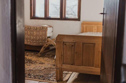 a room with a bed and a table and a window at Foreside Escape Montenegro in Žabljak