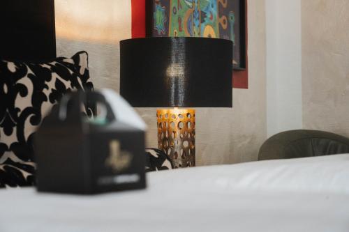 a lamp sitting on top of a table next to a bed at Alpin & Wellness Resort Ludwig Royal in Oberstaufen