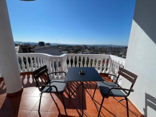 a table and chairs on a balcony with a view at Vila Nikollaj in Kamëz
