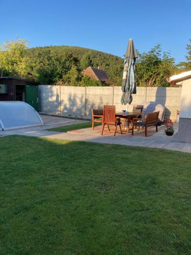 a patio with a table and an umbrella at Wellness Villa Diana in Boldogkőváralja