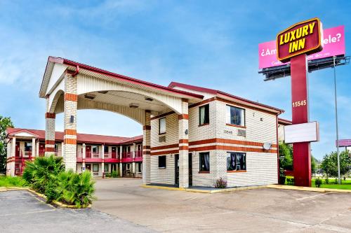 a hotel building with a sign in front of it at Hotel O Luxury Inn Channelview Baytown I-10 in Channelview