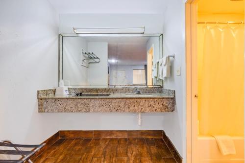 a bathroom with a sink and a mirror at Hotel O Luxury Inn Channelview Baytown I-10 in Channelview