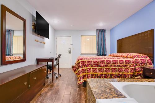 a hotel room with a bed and a sink at Hotel O Luxury Inn Channelview Baytown I-10 in Channelview