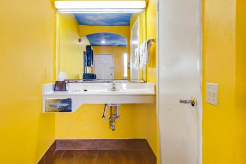 a bathroom with a sink and a mirror at Hotel O Luxury Inn Channelview Baytown I-10 in Channelview