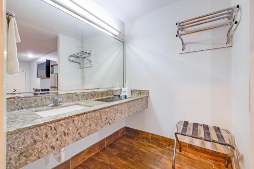 a bathroom with a sink and a mirror at Hotel O Luxury Inn Channelview Baytown I-10 in Channelview