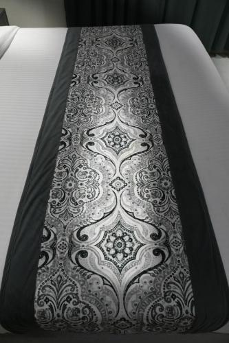 a bed with a black and white carpet on it at Hotel Mountain Bliss' New Delhi City center in New Delhi