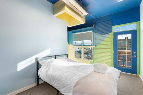 a bedroom with blue and green walls and a bed at Tranquil 3-Bedroom Home in Prince George in Prince George