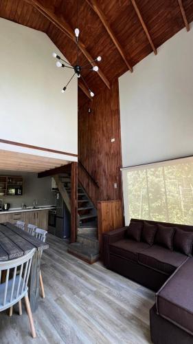 a living room with a couch and a staircase at Inspiramide Pucon in Pucón