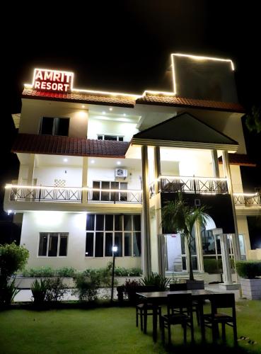 a restaurant with a table in front of a building at Amrit resort in Alwar
