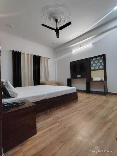 a bedroom with a bed and a ceiling fan at Amrit resort in Alwar