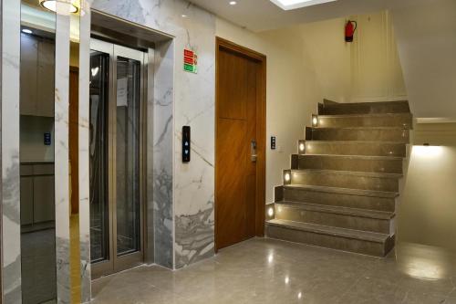 a lobby with stairs and a wooden door at Hotel Mountain Bliss' New Delhi City center in New Delhi