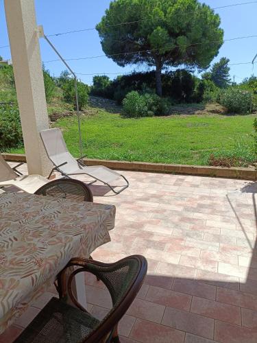 a patio with a table and chairs and a tree at Colibri41elba-Mami Suite in Trappola