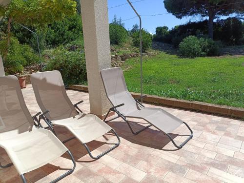 a group of four chairs sitting on a patio at Colibri41elba-Mami Suite in Trappola