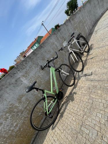 two bikes are parked on a brick wall at Spacious ensuite and lounge with ping pong table - Perfect to rest near the beach in Lavra