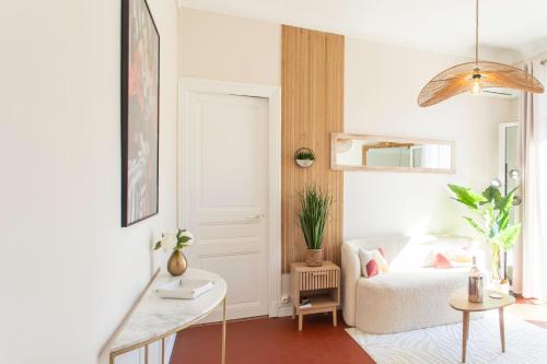 a living room with a chair and a table at Mirabeau Prestige in Antibes