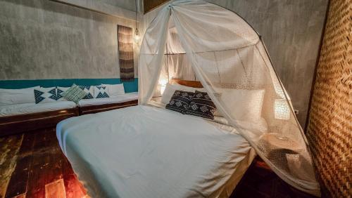 a bed with a canopy in a room at The Verge Cebu Beachfront King Bed Pool Villa - 12 Minutes to Kawasan Falls Canyoneering in Badian