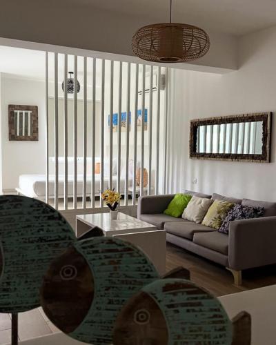 a living room with a couch and a table at punta cana residencial bavaro beach in La Cruz de Mendoza