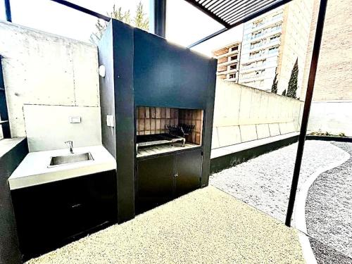 a bathroom with a sink and a fireplace at Premium Studio in Downtown in Neuquén