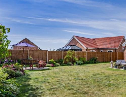 a backyard with a wooden fence and a wooden bench at CrastaPrade LUXHolidayHome in Celerina