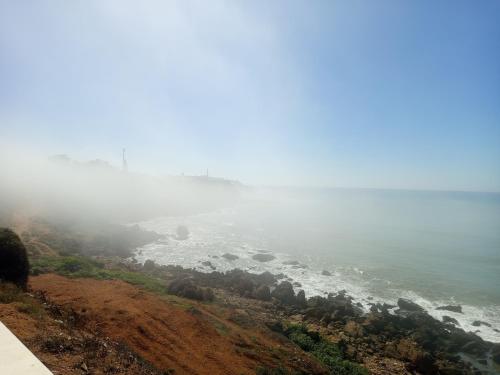 a view of the ocean from the top of a hill at À mi-chemin in Larache