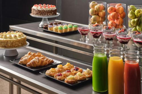 a buffet with many different types of pastries and drinks at Four Points by Sheraton Sydney, Central Park in Sydney