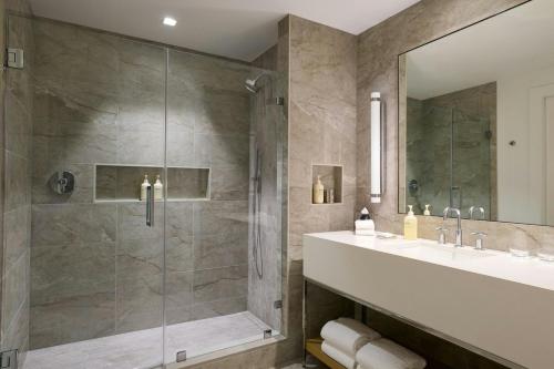 a bathroom with a shower and a sink at JW Marriott Reston Station in Reston