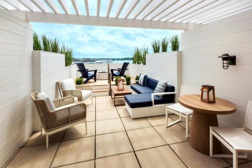 a patio with chairs and tables on a balcony at Newport Marriott Hotel & Spa in Newport