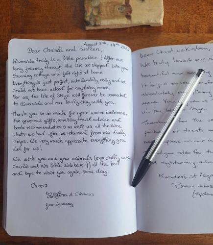 an open notebook with a pen on a table at Riverside in Skeabost