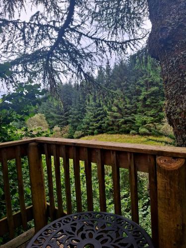 a wooden balcony with a view of a mountain at Riverside in Skeabost