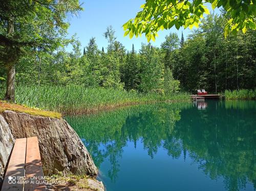 a view of a lake with a boat on it at Hummingbird Room - Modern & Cozy with Bistro Area in Mansonville