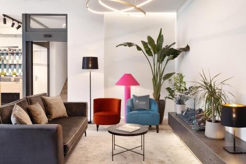 a living room with a couch and a chair at Living Ascona Boutique Hotel in Ascona