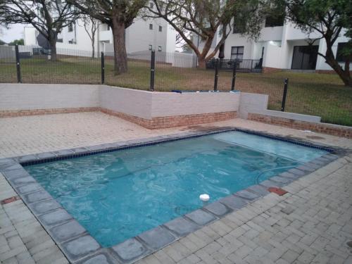 a small swimming pool with a brick retaining wall at Luna Luxury Living in Nelspruit