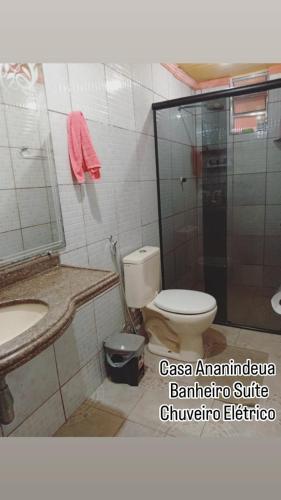 a bathroom with a toilet and a sink and a mirror at Casa Rejane II Cop 30 in Ananindeua